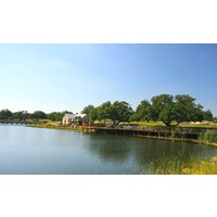 Vaaler Creek Golf Club's clubhouse is small, though there is a large, shaded sitting area beside the pond.
