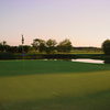 A view of the 10th green surrounded by water at Fox Creek Golf Club