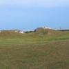 The mounds are almost large enough to hide the houses at Houston National Golf Club. Almost.