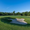 A sunny day view of a hole at Rock Creek Golf Club.
