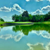 A view over the water of a hole at Proving Grounds Course from Long Cove.