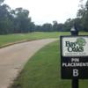 A view of green with water in background at Bay Oaks Country Club