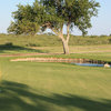 A view of green with water in background at Winkler County Golf Course