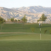 A view of green with mountains in background at Shadow Hills Golf Course