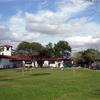A view of the clubhouse and putting green at Llano Grande Golf Course
