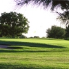 A sunny view of green protected by bunker at Bentwood Country Club