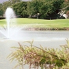 A view of green with water fountain in foreground at Bentwood Country Club
