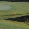 A view of a hole with water on the right at Pine Springs Golf Course