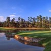 A view of a green surrounded by water at Panther Trail Course from The Golf Trails of The Woodlands