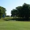 A view of a green with water in background at Gainesville Golf Course