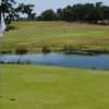 A view of a green with water coming into play at Twisted Oaks Golf Club