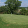 A view of an undulating green with water in background at SugarTree Golf Club