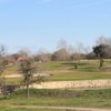 A view of a green protected by a large bunker at Sammy Baugh Golf Course from Western Texas College