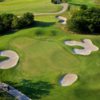 A view of a hole surrounded by a collection of sand traps at Tangle Ridge Golf Club