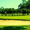 A view of a green protected by a bunker at Southwest Texas Golf Course