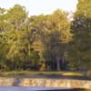View of a green over water at River Plantation Country Club