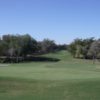 A sunny day view of a hole at Quail Valley Golf Course