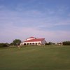 A view of the clubhouse with putting green in foreground at Tierra Verde Golf Club