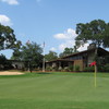 A view of the clubhouse with green #18 in foreground at The Village Golf Club