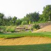 A view of a green with a bunker in foreground at Lighthouse Country Club