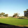 A view of a fairway and the practice putting green in foreground at Sunset Country Club.