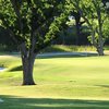 A view of green with narrow path on the left at Stone Creek Golf Club