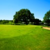 A sunny day view of a green at Riverhill Country Club.