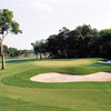 A view of green guarded by bunkers at Pecan Valley Golf Club