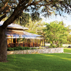 A view of the clubhouse with putting green on the right at Fair Oaks Ranch Golf & Country Club