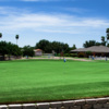 A view of the clubhouse and practice putting green at Howling Trails Golf Course.